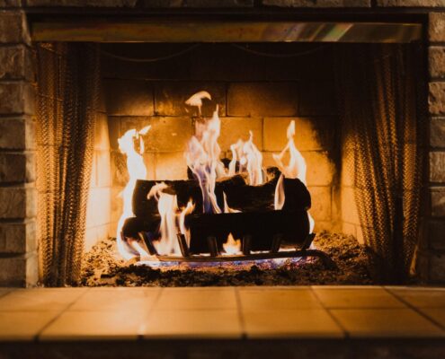 Avoid Chimney Cleaning Logs, logs burning in indoor fireplace