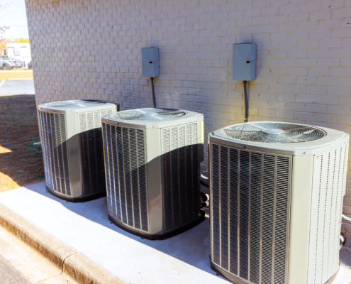 An outdoor air conditioning units has been installed on exterior facade of new house
