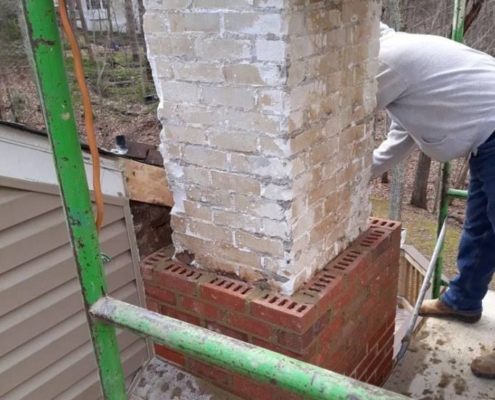 Historic brick home in Alexandria, VA with Sixpenny Chimney Sweeps inspecting the chimney for leaks and maintenance.